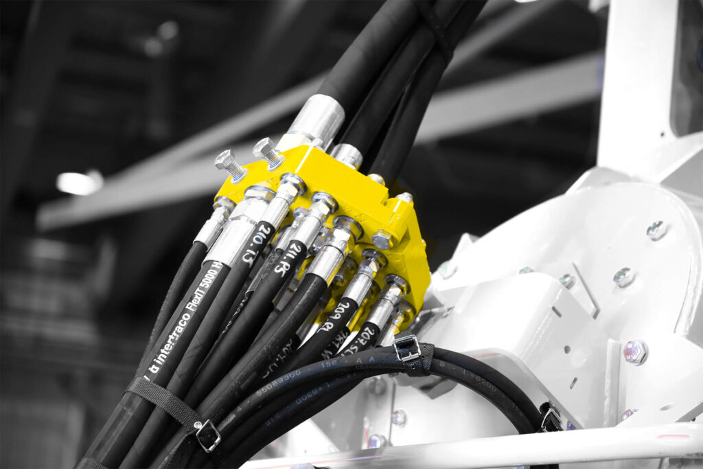A white machine with yellow hoses attached to it.