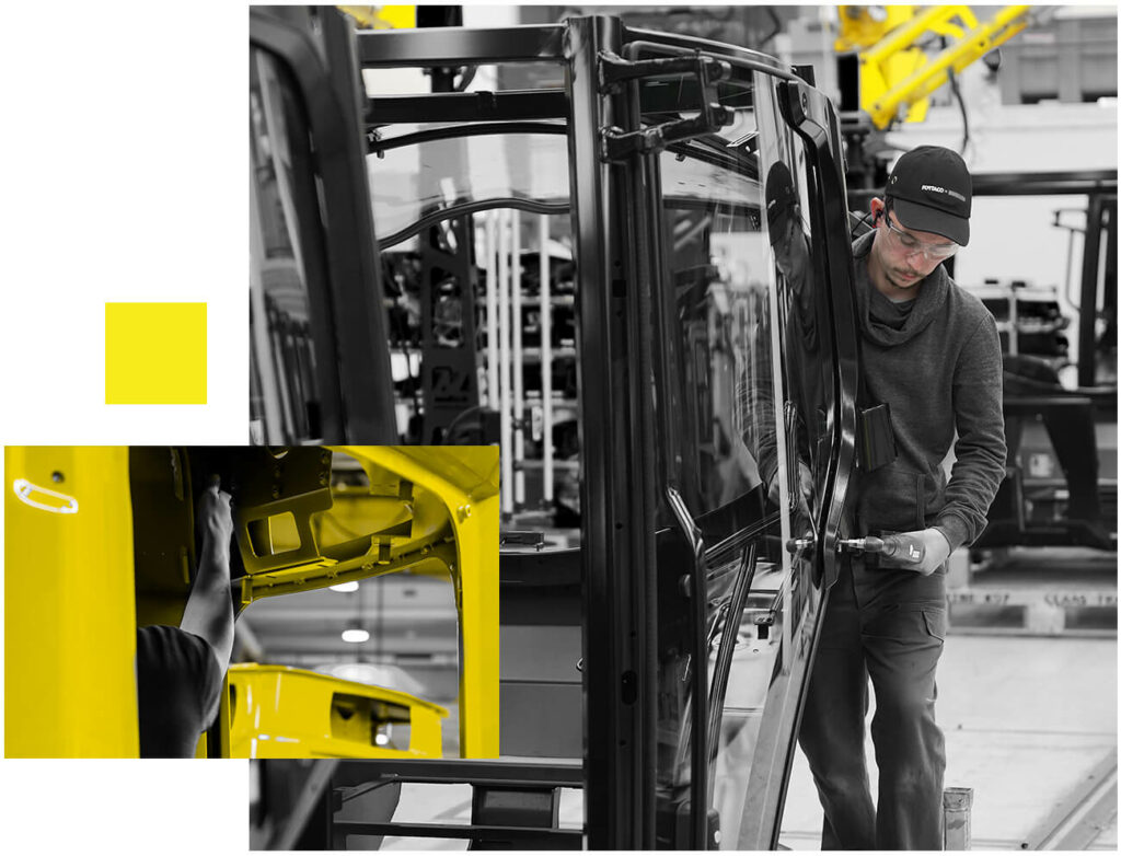 A black and white photo of a man working on a yellow truck.