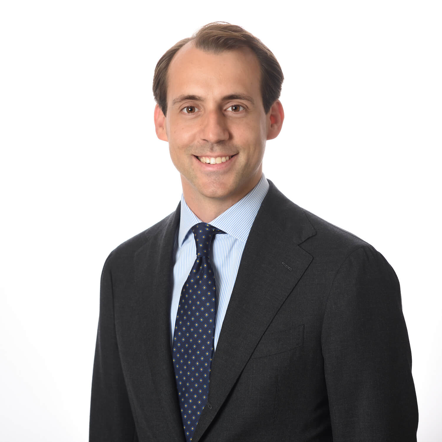 A man in a suit and tie smiling.