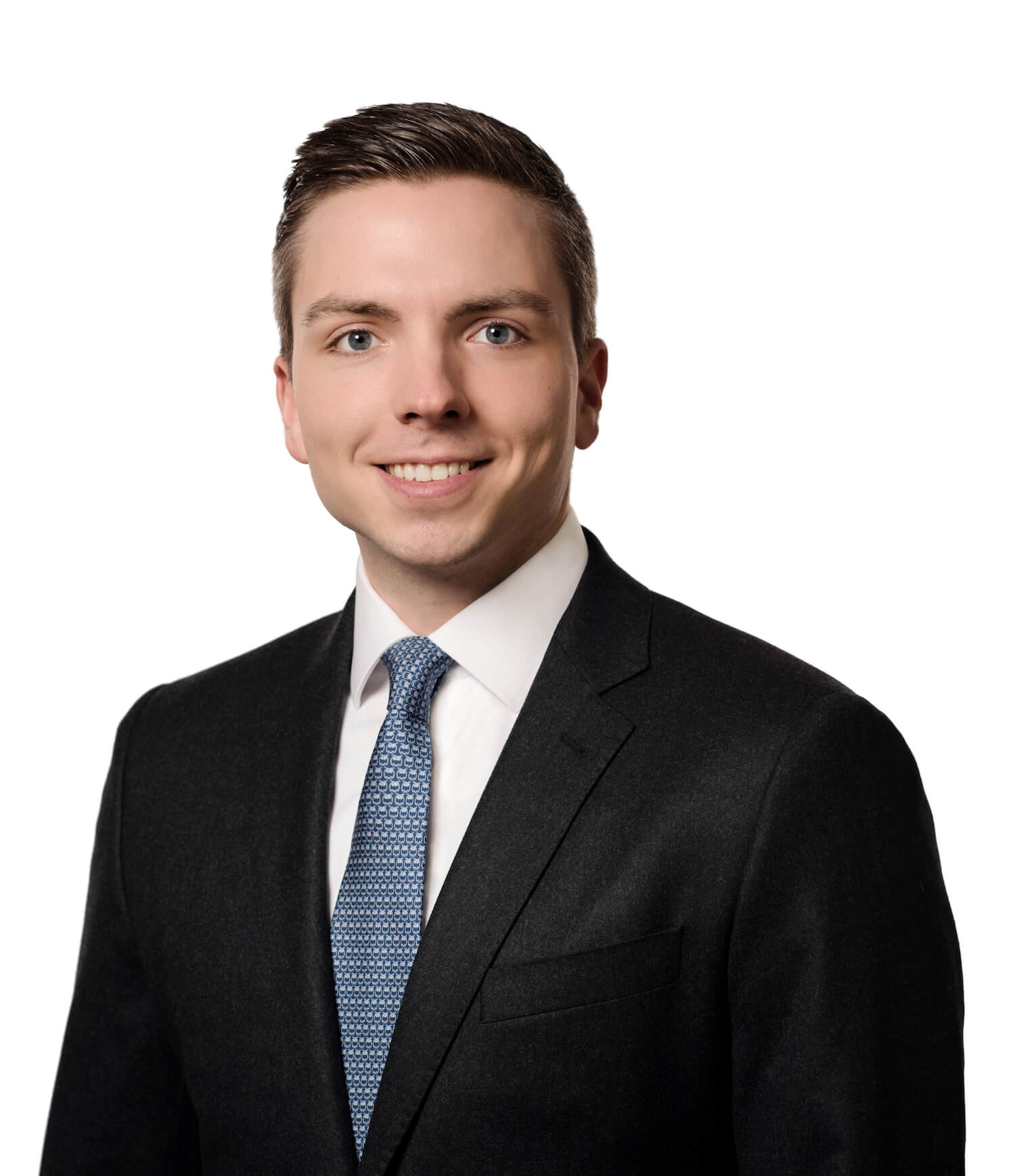 A man in a suit and tie poses for a photo.